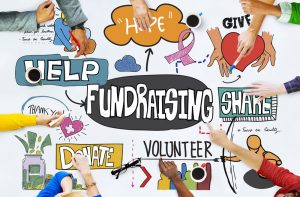 Fundraising graphic. Hands pointing to different fundraising related words on a table.