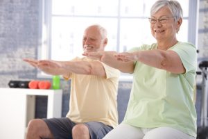 Senior people exercising happily in the gym.