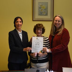 Photo of Noha and Iza presenting certificate to Inner Wheel President